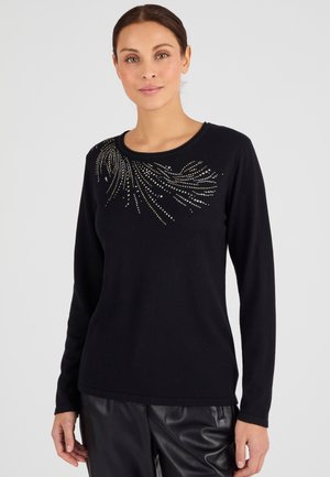 Pull long noir à manches longues, avec un col rond et des embellissements en argent et or dispersés formant un motif tourbillonnant sur la poitrine.