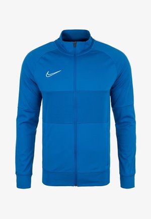 Blaues Nike Sportjacke mit Reißverschluss, langen Ärmeln und hohem Kragen, mit weißem Nike Swoosh-Logo auf der Brust.