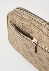Brown textured zippered bag with an embossed pattern, featuring a front pocket and metallic zipper hardware. Compact design.