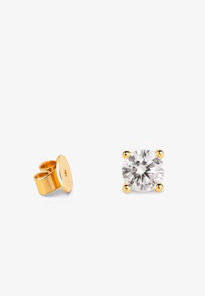 Gold stud earrings featuring a large round clear stone held by four gold prongs, with a matching gold back fastening.