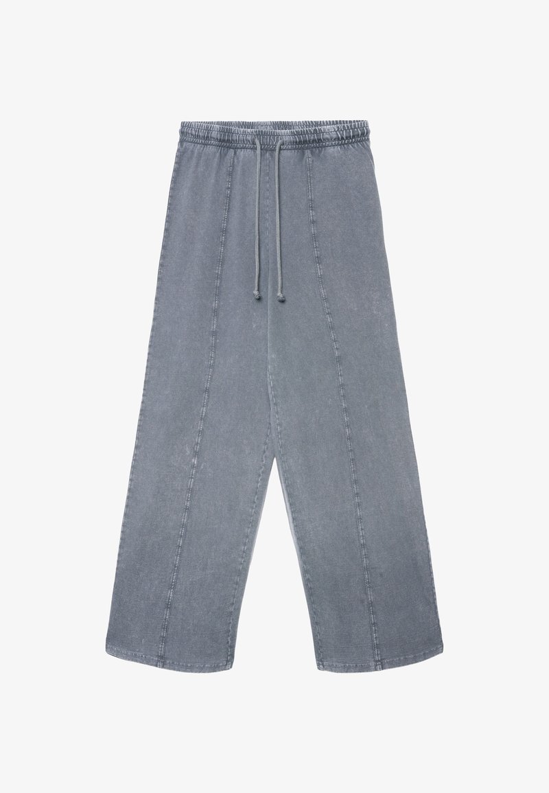 Grau Jeanshose mit elastischem Bund, Kordelzug, weitem Bein und sichtbaren Nahtdetails. Glatte Textur mit einem verwaschenen Finish.