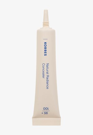Tube de correcteur Korres Natural Radiance, couleur crème, design élancé, texte bleu, embout fin, base striée. Marquages de taille visibles sur le côté.