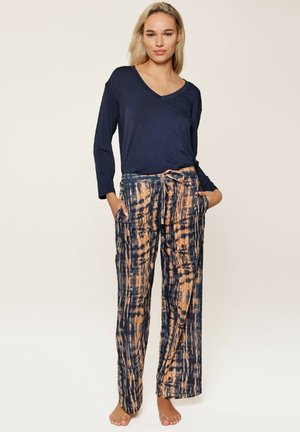 Navy long-sleeve v-neck top paired with orange and navy tie-dye wide-leg pants with pockets. Fabric appears soft and lightweight.