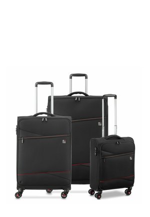 Three black travel suitcases made of fabric, featuring red accents, recessed zippers, and four wheels for mobility, with retractable handles.