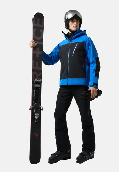 Ski equipment featuring a black and blue insulated jacket, black pants, black gloves, and a snowboard with bold lettering and bindings.
