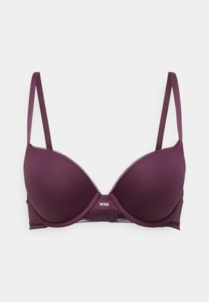 Tumedas lilla rinnahoidja sujuvate polsterdatud tasside, reguleeritavate rihmade ja pitsdetailidega äärtes. Keskel on metallist logo.