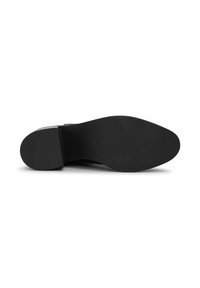 Black shoe sole with a smooth texture, slightly rounded shape, and rectangular heel. Features minimal detailing and no visible patterns.