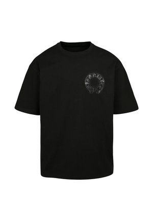 Fekete pamut póló, kör alakú grafikával, amelyen a "Gonzales" szó és egy koponyához hasonló minta látható. Rövid ujjú és kerek nyakú.