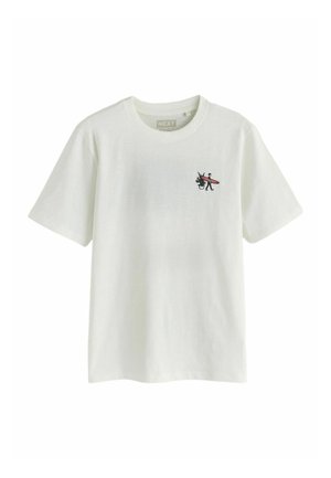 T-shirt blanc manches courtes avec un petit dessin sur la poitrine représentant une personne portant une planche de surf à côté d’une plante en pot.