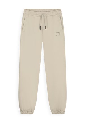 Beige joggingsbroek met elastische tailleband en pijpzomen, trekkoord, zijzakken en een klein rond logo op de linker dij.