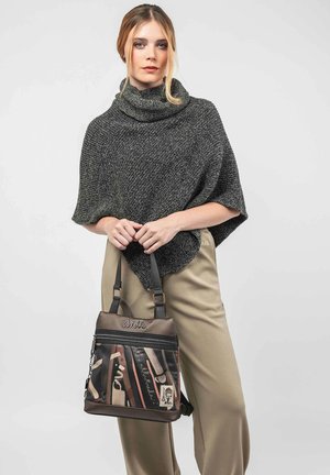 Bolso de hombro marrón y negro con un diseño de materiales mixtos, cremalleras y patrones impresos. El bolso tiene correas cortas y un acabado texturizado.