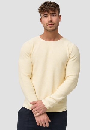 Lys gul strikket genser med lange ermer, rund hals og strukturert stoff. Har en tettsittende design og subtile fargevariasjoner.