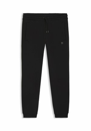 Pantaloni della tuta neri realizzati in tessuto morbido, dotati di una vita elastica con coulisse, tasche laterali e una piccola etichetta con logo.