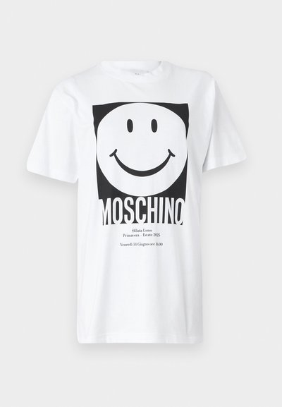 Camiseta de algodón blanca con un gráfico cuadrado negro que muestra una cara sonriente y el texto "MOSCHINO" en la parte inferior. Manga corta, cuello redondo.