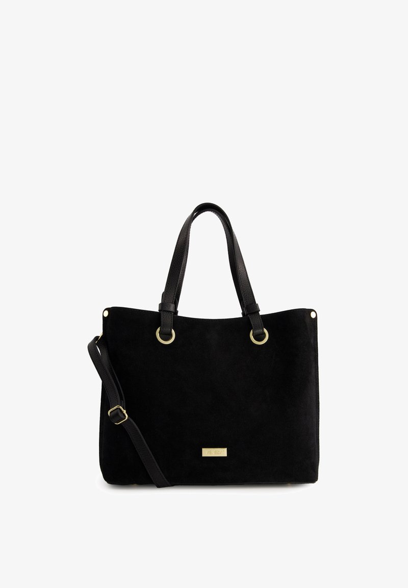 Black suede tote bag with dual black handles, gold hardware accents, and adjustable shoulder strap. Features a metallic logo plate.