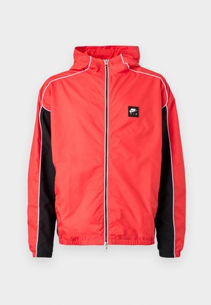 Veste à capuche Nike Air rouge avec panneaux latéraux noirs, passepoil blanc et zip frontal, poignets et ourlet élastiques.