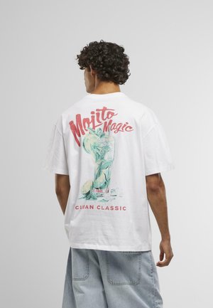 White cotton t-shirt with a colorful "Mojito Magic" graphic on the back, featuring a glass with mint and lime. Text: "Cuban Classic."