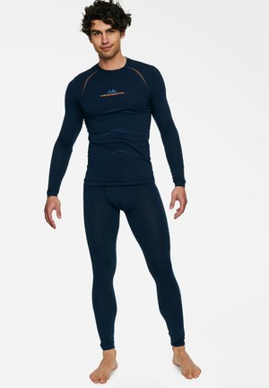 Marineblaues Thermo-Basisschicht-Set mit langen Ärmeln und Leggings. Enthält dehnbare Materialien und ein dezentes Muster auf dem Stoff. Bedrucktes Logo enthalten.