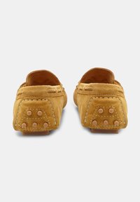 Žute nubuk loafers cipele s glatkom teksturom, s dekorativnim šavovima i gumiranim potplatima s čepovima za bolje prianjanje i izdržljivost.