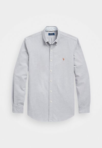 Light gray button-up shirt made of woven cotton. Features a collar, long sleeves, and a small embroidered logo on the left chest.
