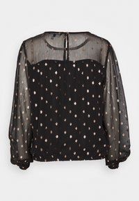 Blusa nera con maniche trasparenti, caratterizzata da un motivo a pois oro e rosa, scollo rotondo e chiusura a bottoni sul retro. Orlo elasticizzato.