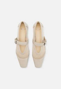 Beige mesh and smooth leather shoes with a square toe, featuring a side buckle and a breathable design. Appropriate for warmer weather.