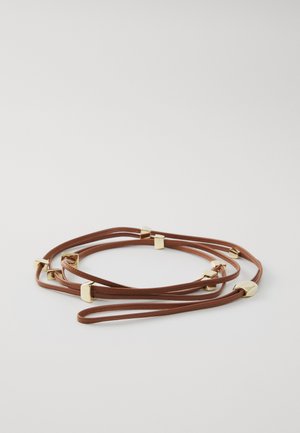 Brown leather strap bracelet featuring gold geometric accents. The design includes multiple intertwined strands with smooth texture.