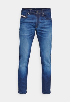 Blå denimjeans med slim passform, med fem-lommers design, kontrasterende søm og en lett falming på frontpanelene.