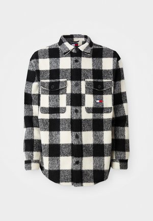 Black and white checkered flannel shirt with long sleeves, button-up front, two chest pockets, and a small logo patch on the left pocket.