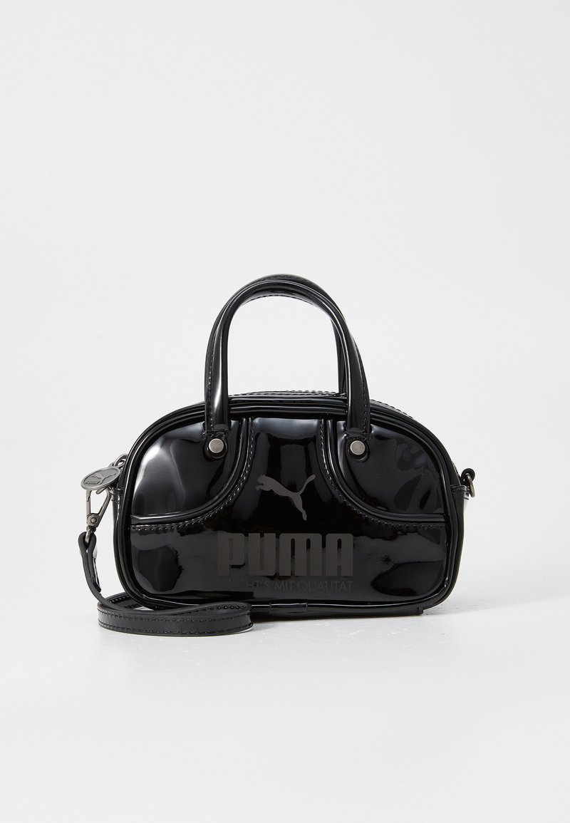 Black patent leather handbag with dual top handles, detachable shoulder strap, rounded shape, and prominent embossed "PUMA" logo.