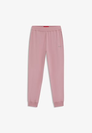 Roze sweatpants van zachte stof, met een rekbare tailleband en geribbelde boorden. Subtiele brandingdetails in zilver op het been.