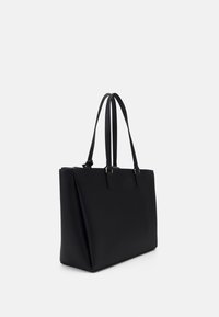 Czarna torba typu tote o strukturalnym designie, wykonana z teksturowanego materiału. Posiada dwa długie uchwyty oraz minimalne akcenty sprzętowe.