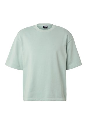 T-shirt oversize à manches courtes vert clair avec col rond et étiquette Urban Classics au niveau du col.