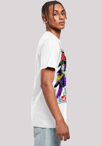 White cotton t-shirt featuring a colorful graphic design of a character with green hair and purple attire. Short sleeves, relaxed fit.