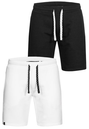 Zwart-witte sportshorts van een katoenen mix. Kenmerken zijn een elastische tailleband, koordjes met een kruispatroon en zijzakken.