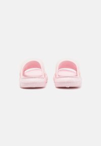 Pink rubber sandals with a textured strap, open back, and a speckled design on the sole. Both sides show a matching color and finish.