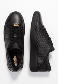 Baskets noires présentant un design en cuir lisse et tissé texturé. Comprend des lacets noirs et des accents de matériel doré.