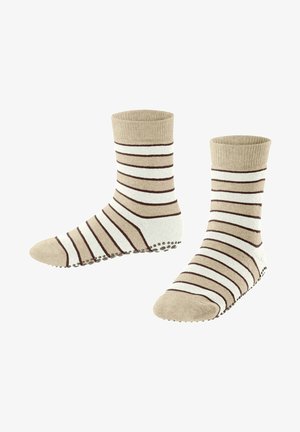 Beżowo-kremowe skarpetki w paski z prążkowanym mankietem i antypoślizgową podeszwą w kropki. Posiadają poziome brązowe paski dla dodatkowego detalu.