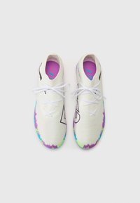 White athletic shoes with a textured knit upper, multicolored sole, purple insole, and contrasting black logo detail. White laces.