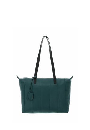 Sac cabas en cuir bleu sarcelle avec poignées noires, motif vertical cousu, et une petite étiquette attachée. Texture lisse, forme rectangulaire.