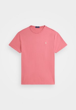Rosa bomull t-skjorte med rund hals og korte ermer. Har en liten brodert logo på venstre bryst. Glatt tekstur.