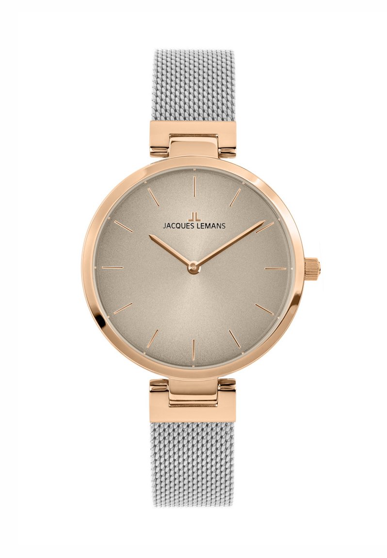 Rund ur med et guldtonet urkasse, beige skive og tynde timeindikatorer. Har et gråt mesh-armbånd og et minimalistisk design.