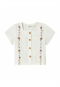 Blusa bianca a maniche corte con scollo quadrato, bottoni in legno e ricami floreali sul davanti. Tessuto leggero con pieghe.