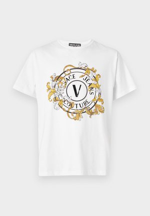 White cotton t-shirt with a round graphic featuring gold and black ornate design, "VERSACE JEANS COUTURE," and a central "V" logo.
