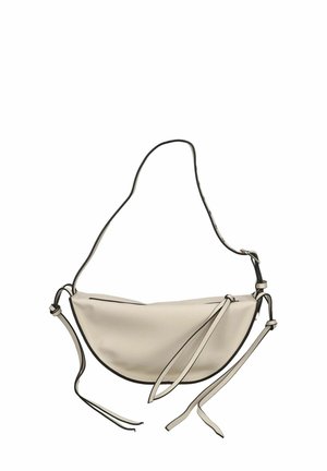Hobo-style bag in soft cream material with black piping. Features a single shoulder strap and ties on either side for closure and adjustment.