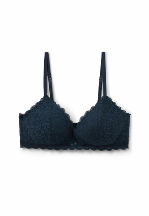 Donker marineblauwe kant bralette met golvende randen en ingewikkelde bloemenpatronen. Heeft verstelbare bandjes en een centrale strikdetail.
