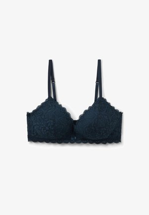 Donker marineblauwe kant bralette met golvende randen en ingewikkelde bloemenpatronen. Heeft verstelbare bandjes en een centrale strikdetail.