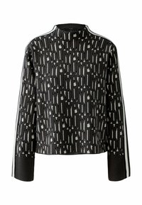 Gebreide coltrui in donkergrijs met een gedurfde zwart-witte print, geribde manchetten en witte zijstrepen. Zachte textuur, cropped fit.