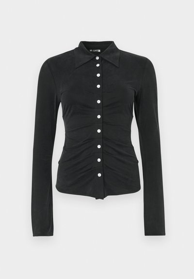 Black long-sleeve shirt with a collared neckline, featuring a button-up front and gathered ruching at the waist and sides. Smooth texture.