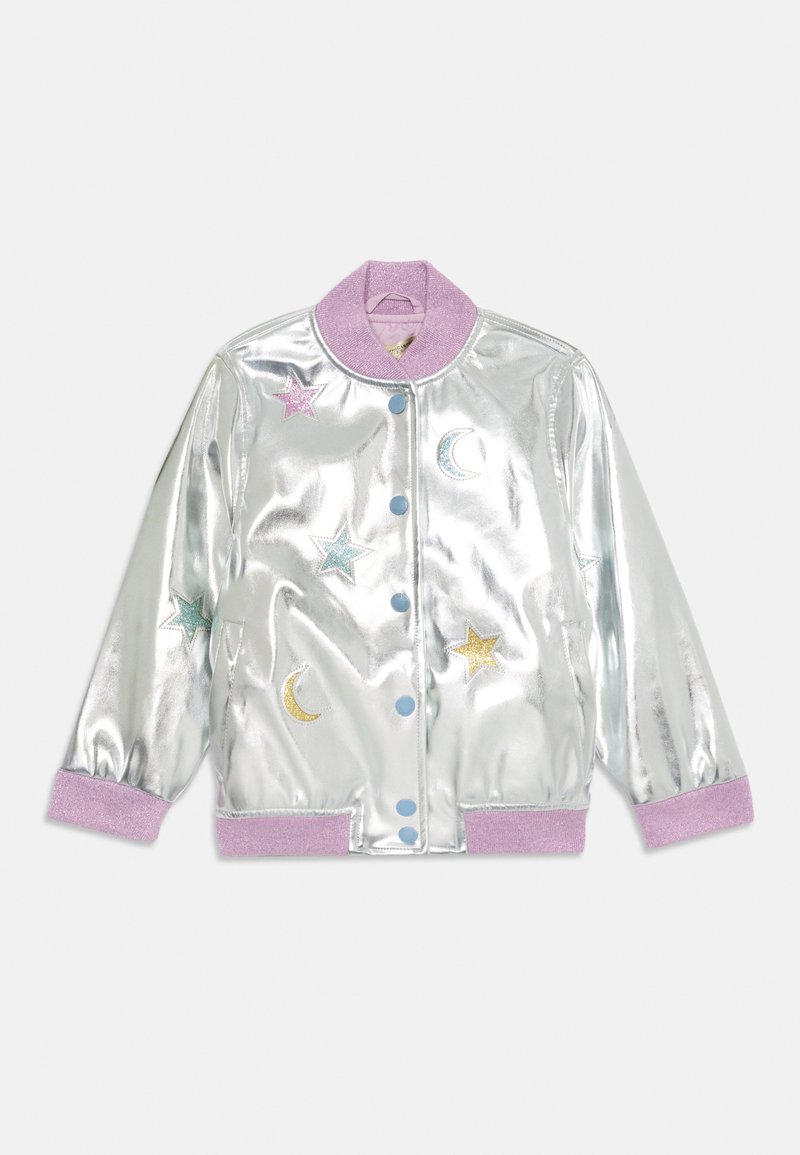 Metallisk sølv bomberjakke med en lilla krage. Har stjerner og halvmåne broderi i rosa, blått og gull. To blå knapper.
